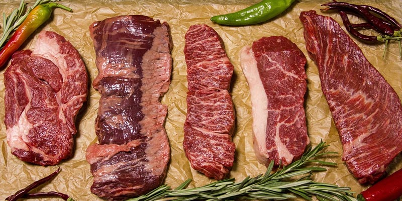 raw steak cut on paper brown bag